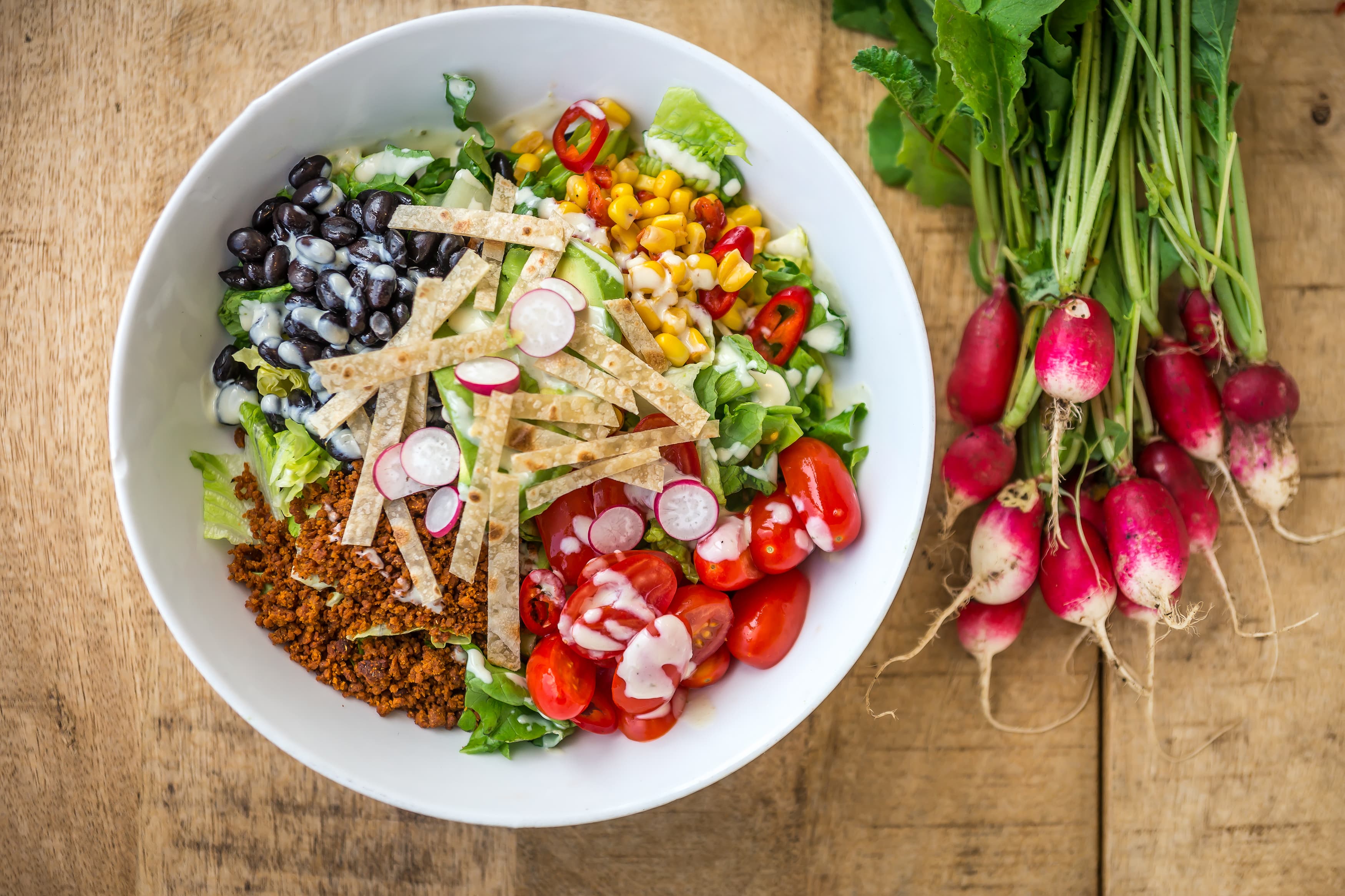 Taco bowl with fresh radish bunch